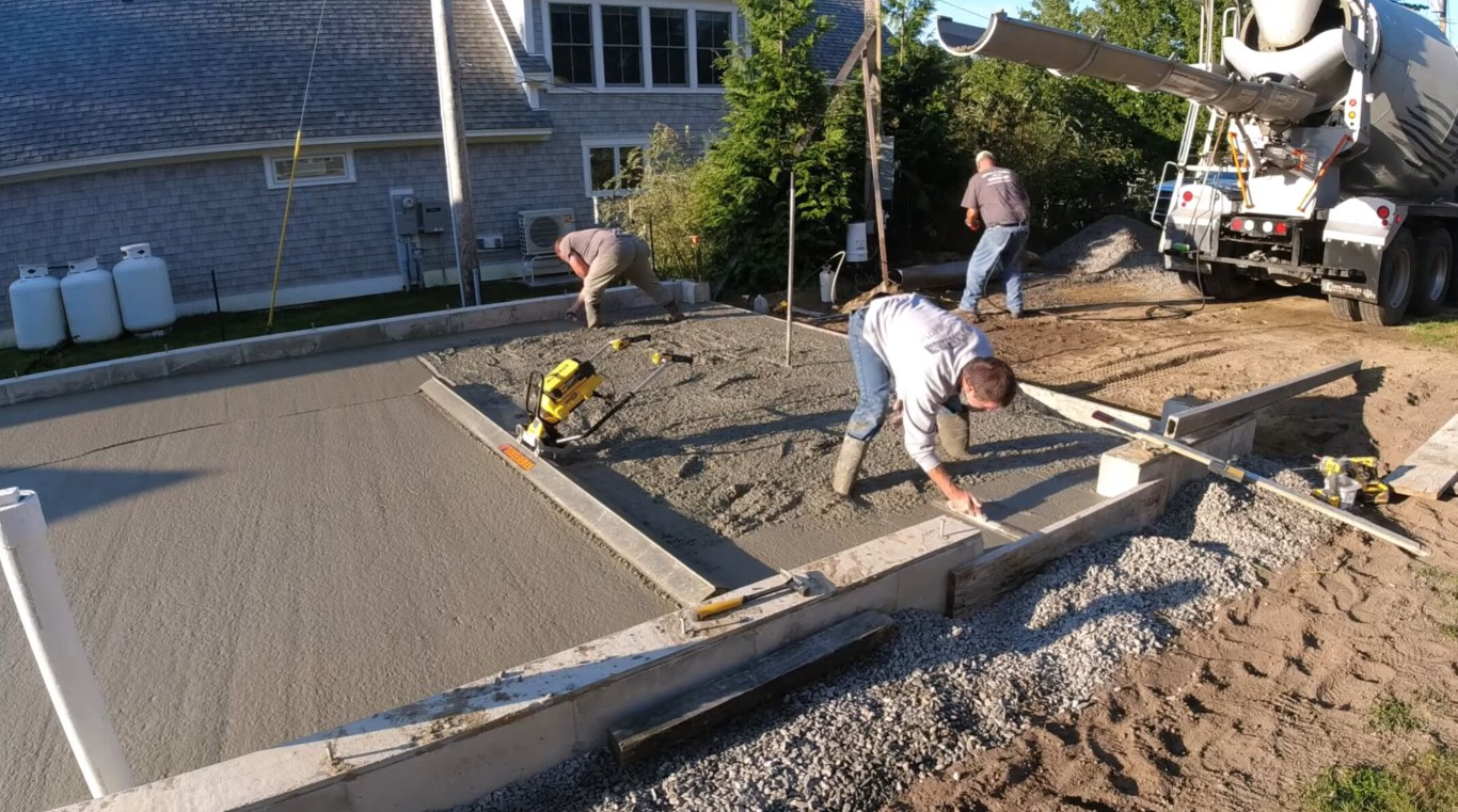 Professional concrete contractors pouring a residential driveway in Wakefield, MA